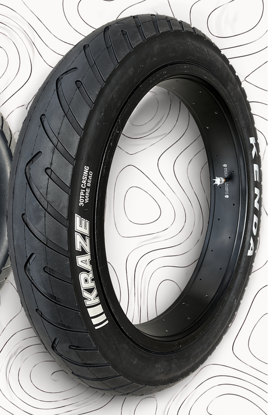 Two Kenda tires on a white background with black tread patterns
